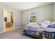 Cozy bedroom featuring natural light from the window and a door to an ensuite bathroom at 105 Biscayne Dr, Port Charlotte, FL 33953