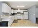 An ample-sized kitchen features white cabinetry and essential appliances for cooking convenience at 105 Biscayne Dr, Port Charlotte, FL 33953