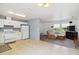 View of kitchen and living room combo featuring a modern sofa and entertainment center at 105 Biscayne Dr, Port Charlotte, FL 33953