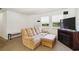 Bright living room with a comfortable sofa, entertainment center, and natural light at 105 Biscayne Dr, Port Charlotte, FL 33953