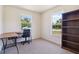 This bright office features two windows, a desk and a bookshelf at 105 Biscayne Dr, Port Charlotte, FL 33953