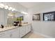 Bright bathroom featuring double sinks, stylish lighting, and a neutral color palette at 1132 Moss Cove Ct, Port Charlotte, FL 33953