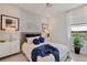 Comfortable bedroom with a ceiling fan, coordinated decor, and natural light from the window at 1132 Moss Cove Ct, Port Charlotte, FL 33953