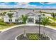 Beautiful clubhouse with pristine landscaping and circular driveway on a bright sunny day at 1132 Moss Cove Ct, Port Charlotte, FL 33953