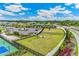 Aerial view of community dog park and tennis courts in a beautifully landscaped and maintained setting at 1132 Moss Cove Ct, Port Charlotte, FL 33953