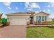 Charming single-story home with a two-car garage, brick accents, and a well-manicured lawn at 1132 Moss Cove Ct, Port Charlotte, FL 33953