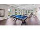 Spacious game room features a pool table, comfortable seating, and plenty of natural light at 1132 Moss Cove Ct, Port Charlotte, FL 33953