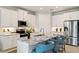 Modern kitchen features white cabinets, stainless steel appliances, granite countertops, and island with seating at 1132 Moss Cove Ct, Port Charlotte, FL 33953