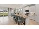 Modern kitchen features white cabinets, stainless steel appliances, granite countertops, and island with seating at 1132 Moss Cove Ct, Port Charlotte, FL 33953