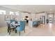 Open-concept kitchen and dining area with stainless appliances, large island, and stylish furniture at 1132 Moss Cove Ct, Port Charlotte, FL 33953