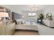 Bright main bedroom features a tufted headboard, dresser, and a window at 1132 Moss Cove Ct, Port Charlotte, FL 33953