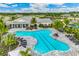 Beautiful community pool with lounge chairs, tables and landscaping in a beautiful clubhouse setting at 1132 Moss Cove Ct, Port Charlotte, FL 33953