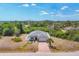 Birds-eye view of a lovely single-Gathering home with a two-car garage, a brick-paved driveway and a fenced backyard at 118 Boxwood Ln, Rotonda West, FL 33947