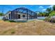 A backyard view of the screened-in pool and patio at 118 Boxwood Ln, Rotonda West, FL 33947