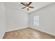 Empty bedroom with tile floors, a ceiling fan, a window with blinds, and neutral decor at 118 Boxwood Ln, Rotonda West, FL 33947