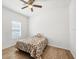 Cozy bedroom with tile floors, ceiling fan, natural light, and neutral decor at 118 Boxwood Ln, Rotonda West, FL 33947
