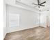 Large bedroom featuring wood-look tile flooring, neutral paint, a ceiling fan, and abundant natural light at 118 Boxwood Ln, Rotonda West, FL 33947