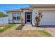 Close-up of the front door of a single-Gathering home, surrounded by tasteful landscaping at 118 Boxwood Ln, Rotonda West, FL 33947