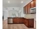 Modern kitchen with wood cabinets, granite countertops, stainless steel appliances and an eat-in island at 118 Boxwood Ln, Rotonda West, FL 33947
