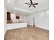 Open-concept kitchen with bar, pendant lighting, breakfast bar, stainless steel appliances, and wood-look tile flooring at 118 Boxwood Ln, Rotonda West, FL 33947