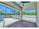 View of the screened-in lanai with brick pavers and view of the fenced backyard at 118 Boxwood Ln, Rotonda West, FL 33947
