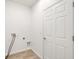 Clean and well-lit laundry room with tile flooring and washer/dryer hookups at 118 Boxwood Ln, Rotonda West, FL 33947