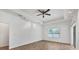 Spacious living room with tile floors, a ceiling fan, a window with blinds, and modern track lighting at 118 Boxwood Ln, Rotonda West, FL 33947