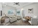 Bright living room features tile floors, a ceiling fan, and sliding glass doors to a screened-in porch at 118 Boxwood Ln, Rotonda West, FL 33947