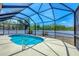 The screened-in pool features a metal ladder and concrete patio surround at 118 Boxwood Ln, Rotonda West, FL 33947