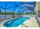 A screened-in pool sits within a concrete patio and backyard setting at 118 Boxwood Ln, Rotonda West, FL 33947