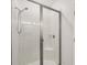 Bright shower featuring white tile surround, a glass door and built-in seat at 118 Boxwood Ln, Rotonda West, FL 33947