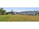 Spacious backyard featuring a well-maintained lawn and a home with a white exterior at 124 Rotonda Cir, Rotonda West, FL 33947