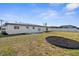 Well-maintained backyard with lush grass and mulch accents and a white fence for privacy at 124 Rotonda Cir, Rotonda West, FL 33947