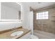 Bathroom featuring illuminated mirror, tub with shower, and neutral color palette at 124 Rotonda Cir, Rotonda West, FL 33947