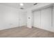 Bedroom with neutral paint, wood-look floors, ceiling fan, and closet at 124 Rotonda Cir, Rotonda West, FL 33947