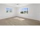 Sun-lit bedroom with wood-look floors and two large windows with beautiful views at 124 Rotonda Cir, Rotonda West, FL 33947