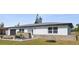 Charming single-story home with a rock garden, a dark garage door, and a well-kept lawn at 124 Rotonda Cir, Rotonda West, FL 33947