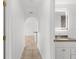 Hallway featuring neutral paint, tile floors, and views into the bathroom and living room at 124 Rotonda Cir, Rotonda West, FL 33947