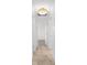 Hallway view with tile floors, neutral paint, and views into bedrooms at 124 Rotonda Cir, Rotonda West, FL 33947