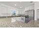 Open kitchen showcasing granite countertops, white cabinetry, stainless steel appliances, and a modern design at 124 Rotonda Cir, Rotonda West, FL 33947