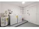 Laundry room featuring a washer, dryer, water heater, and plenty of room for storage at 124 Rotonda Cir, Rotonda West, FL 33947