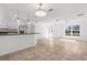 Spacious living area features tile flooring, an open layout, pendant lighting, and natural light from a large window at 124 Rotonda Cir, Rotonda West, FL 33947