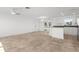 A spacious living room features tile floors, white walls, an open layout, and a doorway to the back patio at 124 Rotonda Cir, Rotonda West, FL 33947