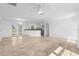 Bright living room with tile floors, ceiling fan, and open access to the modern kitchen at 124 Rotonda Cir, Rotonda West, FL 33947