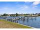 Scenic waterfront view featuring boat docks, calm waters, and waterfront homes in the distance on a clear day at 124 Rotonda Cir, Rotonda West, FL 33947