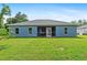 Exterior view of the home with a screened patio and large backyard at 1275 Huntington St, North Port, FL 34288