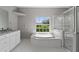 Bright bathroom featuring a large soaking tub and a glass shower at 1275 Huntington St, North Port, FL 34288