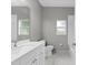 Well-lit bathroom with white cabinets, a large mirror and a shower-tub combination at 1275 Huntington St, North Port, FL 34288