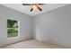Bright, airy bedroom with tile floor and large window at 1275 Huntington St, North Port, FL 34288