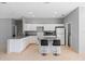 Well-lit kitchen featuring an island with bar stool seating, and a full suite of appliances at 1275 Huntington St, North Port, FL 34288
